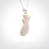 This is a hand carved love heart with love fingers made from bone with sterling silver bale and provided with a sterling silver chain.